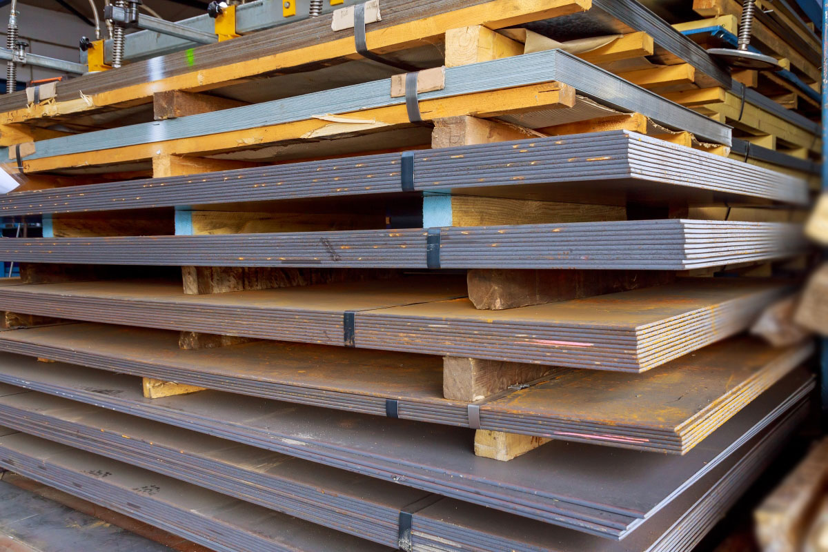 Steel sheets in warehouse, rolled metal product. Sheets of metal